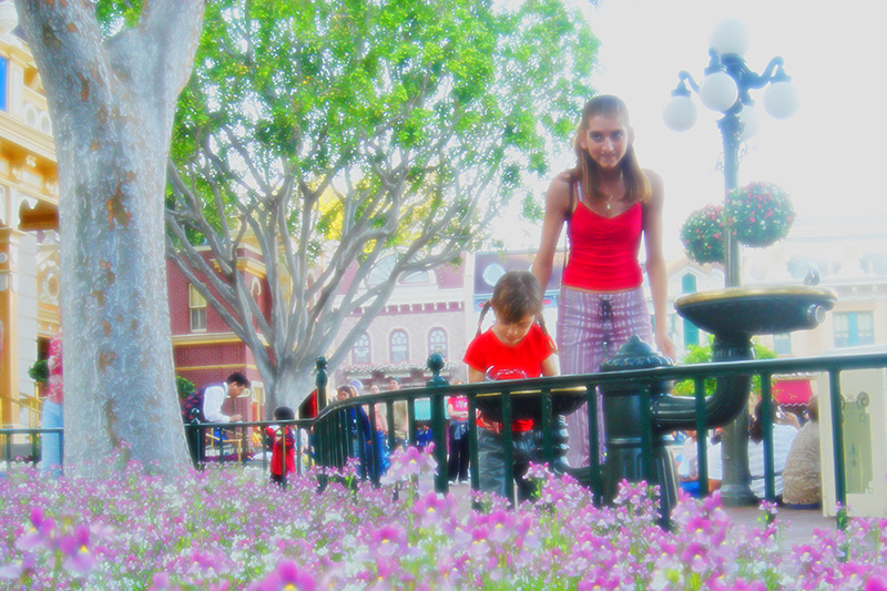20040405 165300 2282
A girl stops for a drink at a fountain with her mother at Disneyland, California.  Colors were enhanced artificially, a soft filter applied and the horizon tilted to create a sense of dreaminess.
